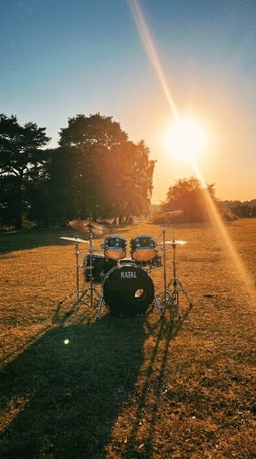 A drum kit in the New Forest at sunset